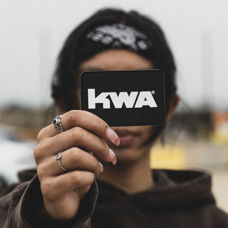 Player holding up a KWA patch