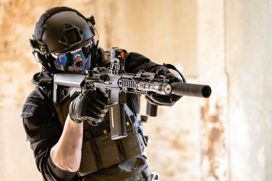 Player aiming a KWA rifle in CQB