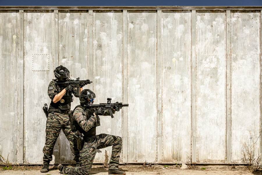 Two airsoft players moving as a team